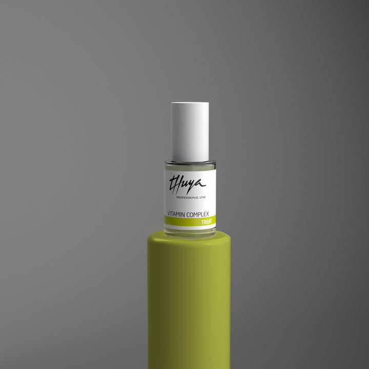 Billedet viser negleproduktet THUYA VITAMIN COMPLEX NAIL TREAT, der er et negleprodukt til intensiv pleje til tørre, skøre, sarte, tynde og/eller dehydrerede negle. Negleproduktet fremvises på et grønt piedestal, der symboliserer Thuya farvekoder for den korrekte neglebehandling. 